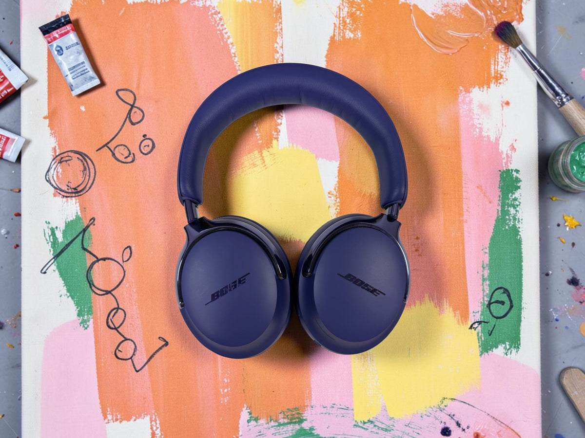 Bose QuietComfort Ultra Headphones (2nd Gen) in Midnight Violet on a hand-painted canvas in an art studio